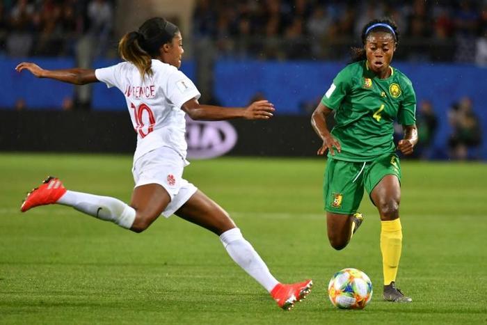 Cameroon's Yvonne Leuko (R) challenges Canada's Ashley Lawrence during the countries' group-stage encounter