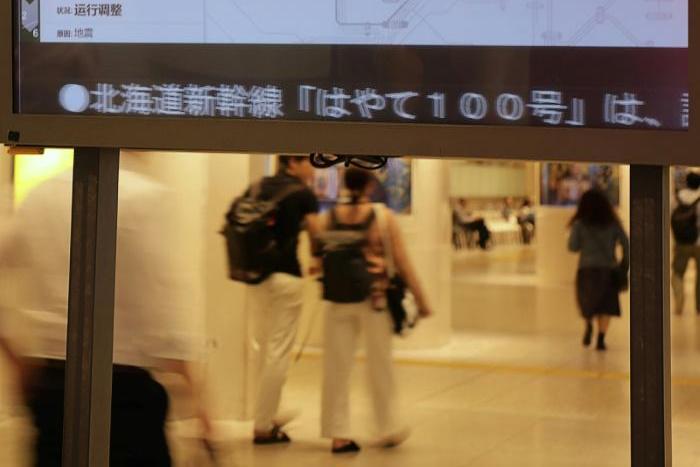 An electronic signboard displays the Jyoetsu bullet train operation suspended between Tokyo and Niigata, following a strong earthquake that rocked Japan