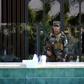 A member of the Iraqi Kurdish security forces stands guard outside the restaurant where two people were shot dead in Arbil