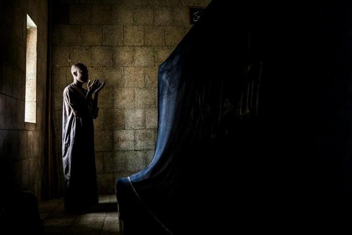 A pilgrim prays before the tomb of Usman Dan Fodio, revered by the Fulani as a holy man
