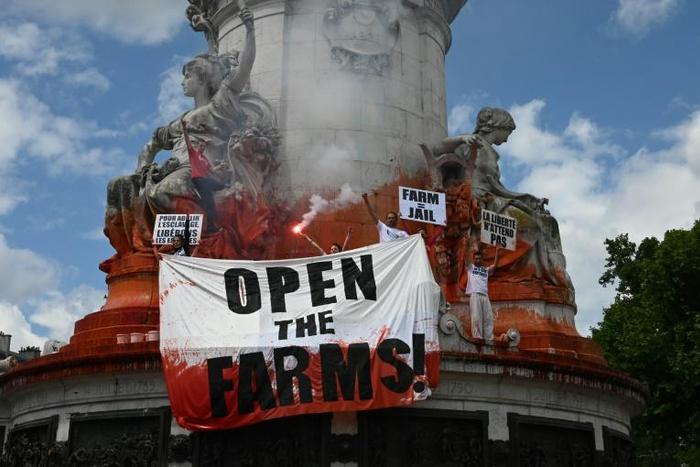Police arrested a small group of activists after they threw fake blood over the statue of Marianne in Place de la Republique