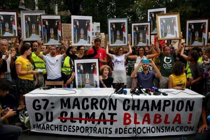 Demonstrators at the so-called "portrait march" were carrying official portraits of the 41-year-old French leader