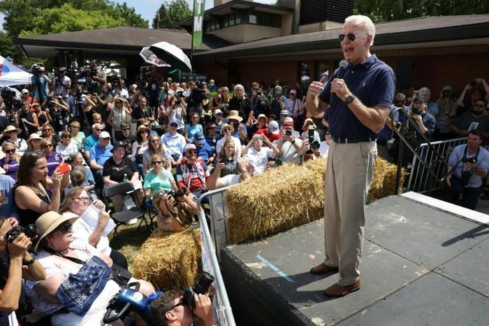 Former Vice President Joe Biden snapped selfies, ate ice cream and navigated a crushing media gaggle that followed his every step at the state fair in Des Moines
