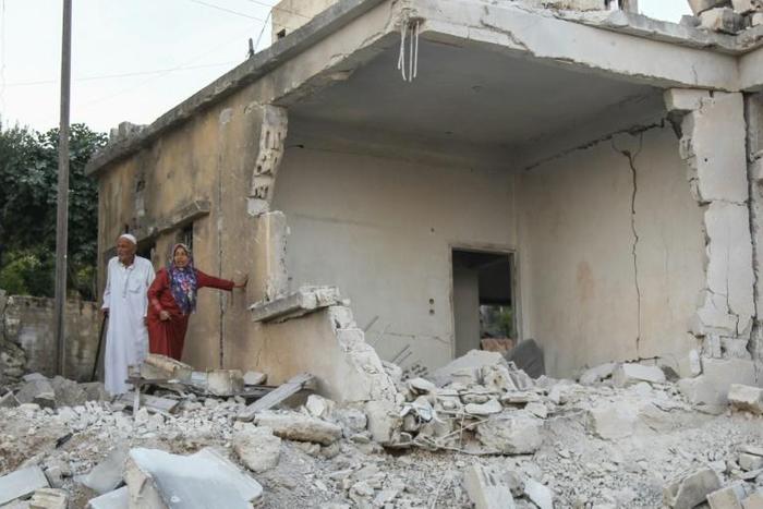 Syrians inspect the damage following reported regime airstrikes on the town of Muhambal, in the northern Idlib province on July 6, 2019
