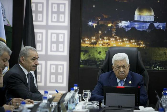 Palestinian prime minister Mohammad Shtayyeh (L) has agreed to cancel planned raises for ministers after they were leaked online