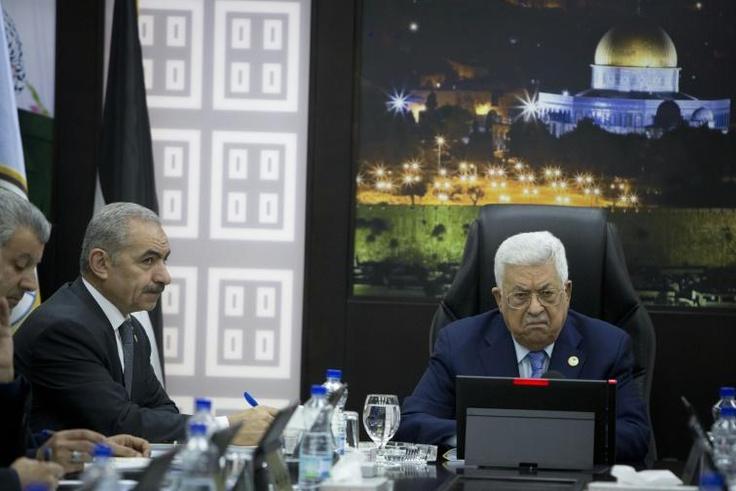 Palestinian prime minister Mohammad Shtayyeh (L) has agreed to cancel planned raises for ministers after they were leaked online