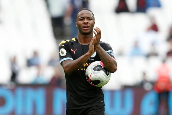Raheem Sterling carries the match ball after scoring a hat-trick for Manchester City against West Ham