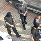 Defendants were escorted by police officers as they arrived in court for the final verdict