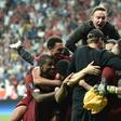 Liverpool players and staff celebrate after beating Chelsea on penalties to win the Super Cup in Istanbul