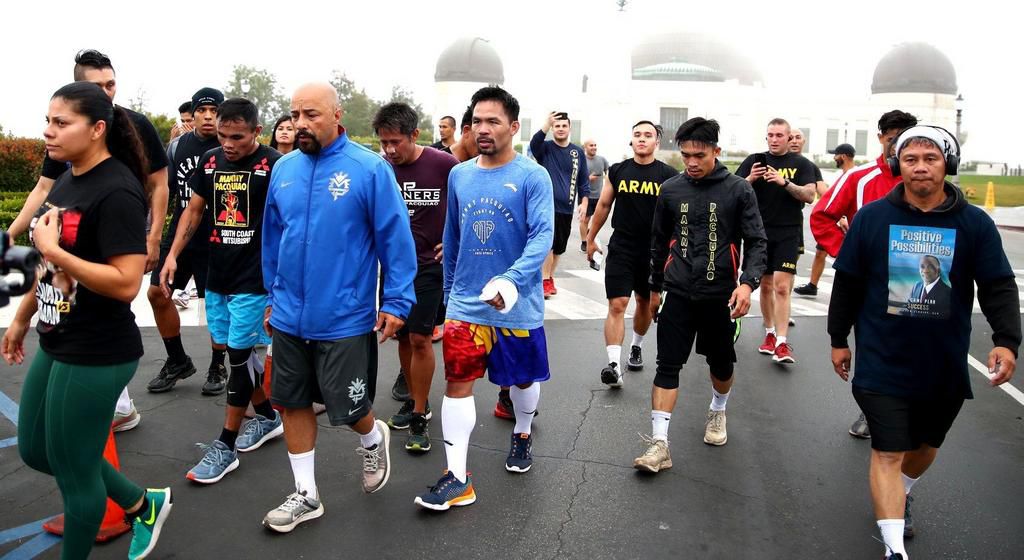 Pacquiao and his crew hitting the road, with the author taking a photo in the rear.