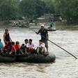 Locals and Central American migrants use a makeshift raft to cross the Suchiate river from Guatemala to Mexico -- Mexico is racing to implement a deal with the United States to curb migration