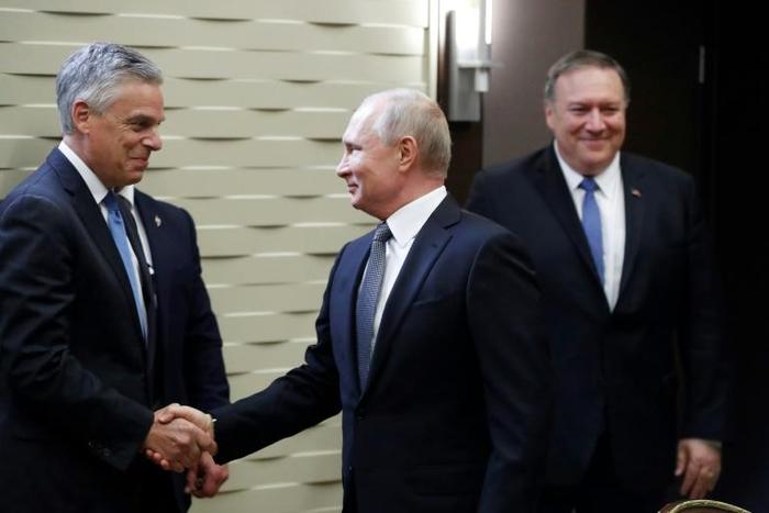 Russian President Vladimir Putin greets US Ambassador to Russia Jon Huntsman