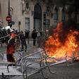 Analysts had believed that the yellow vest movement had lost momentum, but dozens of protestors knocked down security barriers erected for the parade and set fire to refuse bins