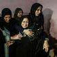 Relatives mourn for one of three Palestinians killed by Israeli fire along the border with the Gaza Strip