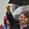 Brazilian President Jair Bolsonaro gives the thumbs-up sign as he arrives in Osaka for the G20 summit