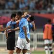 Pep Guardiola gives intructions to his Manchester City players on the sideline in Nanjing