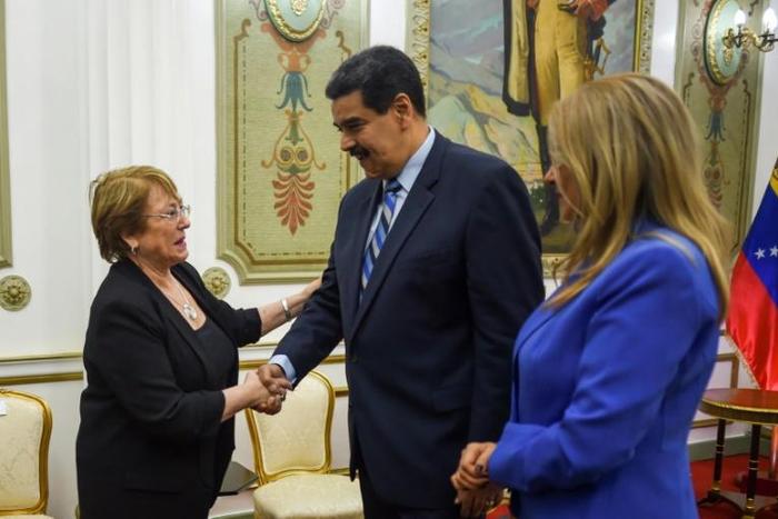 UN High Commissioner for Human Rights Michelle Bachelet (L) greets Venezuelan President Nicolas Maduro (C) next to his wife Cilia Flores at Miraflores Presidential Palace in Caracas, on June 21, 2019