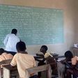 Teachers write exam questions on blackboards