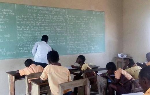 Teachers write exam questions on blackboards