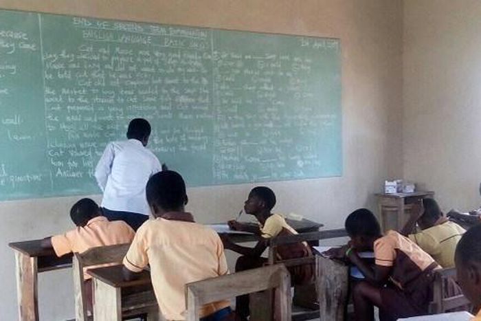 Teachers write exam questions on blackboards