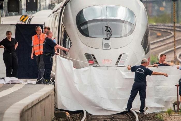 An Eritrean man has been charged with murder and attempted murder for pushing a mother and her son in front of a train as it arrived in Frankfurt
