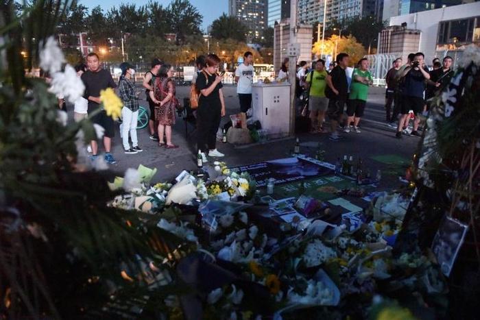 Heart-broken Chinese football fans placed beer, scarves and candles outside Beijing Guoan's stadium in a fast-growing memorial to former forward Walter Martinez, who has died aged 37