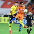 Song Wenjie (C) of Shandong Luneng competes for the ball with Tyias Browning (L) of Guangzhou Evergrande. Evergrande shaded their Chinese rivals 6-5 on penalties