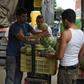 A man sells fruits and vegetables at a street market in Caracas, where a greater choice of products exist, on July 25
