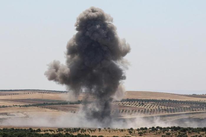 Smoke billows after reported regime air strikes near Khan Sheikhun in Syria's Idlib province