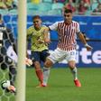 Colombia's Gustavo Cuellar (center) scores through Paraguay goalkeeper Roberto Fernandez's legs