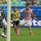 Colombia's Gustavo Cuellar (center) scores through Paraguay goalkeeper Roberto Fernandez's legs