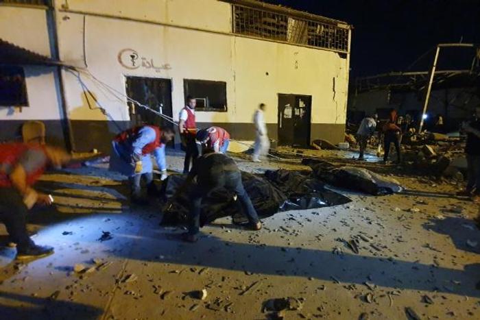 Emergency workers recover bodies after an air strike killed nearly 40 at Tajoura detention centre