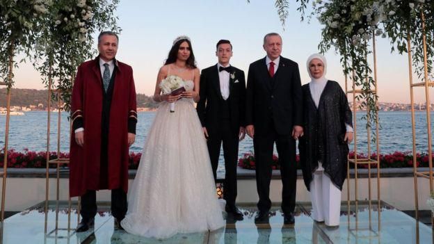 President Erdogan and his wife Emine (right) posed for photos with the newlyweds