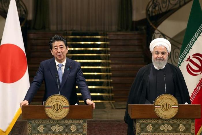 Iranian President Hassan Rouhani and Japanese Prime Minister Shinzo Abe give a joint press conference at the Saadabad Palace in Tehran