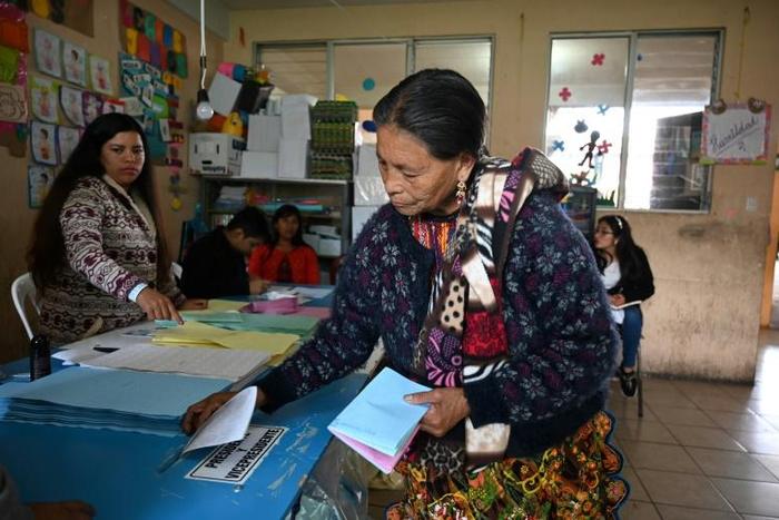 A woman casts her vote at a polling station in San Pedro Sacatepuez, Guatemala, on June 16, 2019