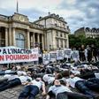 Activists stage a "die-in" on June 4, 2019 to denounce the air quality outside the French National Assembly in Paris