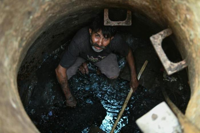 Hundreds of thousands of mostly low-caste Indians are employed as 'manual scavengers' who clear underground pipes and septic tanks without any protective gear or masks