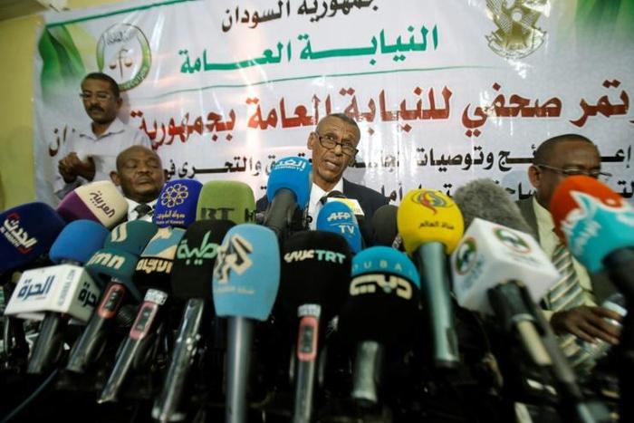Head of a Sudanese investigative committee Fatah al-Rahman Saeed (C) reveals findings of a probe into the deadly raid on a Khartoum protest camp