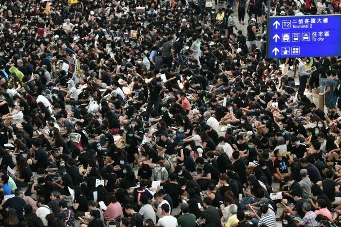 The airport rally was promoted online with a mock boarding pass reading 'HK to freedom' and 'warm pick-up to guests to HK'