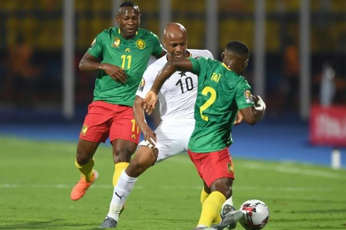 Ghana captain Andre Ayew (C) is outnumbered during an Africa Cup of Nations match against Cameroon in Egypt