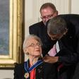 Katherine Johnson, seen here receiving the Presidential Medal of Freedom from Barack Obama, provided pivotal contributions to American space flight research alongside Dorothy Vaughan and Mary Jackson