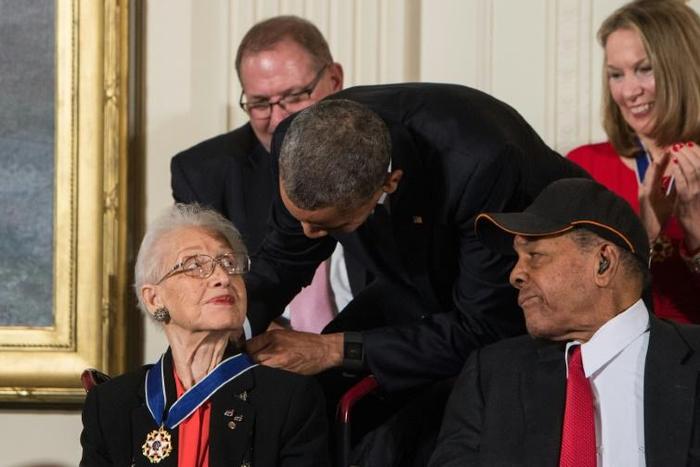 Katherine Johnson, seen here receiving the Presidential Medal of Freedom from Barack Obama, provided pivotal contributions to American space flight research alongside Dorothy Vaughan and Mary Jackson