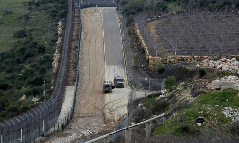 Israeli military vehicles patrol the border fence with Syria in the Israeli-annexed Golan Heights