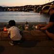 Candles have been lit close to the Danube in memory of the victims