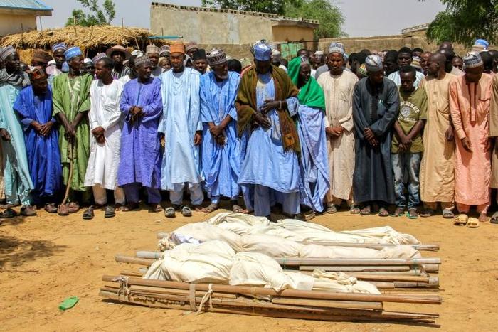 Nigeria is now facing "a mixture" of Boko Haram remnants, criminal groups and jihadists from the Maghreb and West Africa, the president's office said. Here men pray at the burial last week of two Boko Haram victims