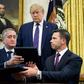 US President Donald Trump watches as Guatemalan Interior Minister Enrique Degenhart (L) and acting US Secretary of Homeland Security Kevin McAleenan conclude an agreement on July 26, 2019 meant to slow the northward flow of migrants