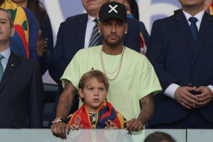 Brazilian injured footballer Neymar and his son Davi Lucca are seen on the stands before the Copa America football tournament final match in Rio de Janeiro, Brazil, on July 7, 2019. Neymar failed to show up for pre-season training with Paris Saint-Germ...