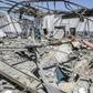 Military officers of the Libyan Government of National Accord (GNA)inspect damage at a migrant detention center in the capital Tripoli's southern suburb of Tajoura on July 3, 2019, following an air strike on a nearby building that left dozens killed
