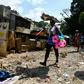 A woman sells toys at the site of a landslide in Port-au-Prince on July 3