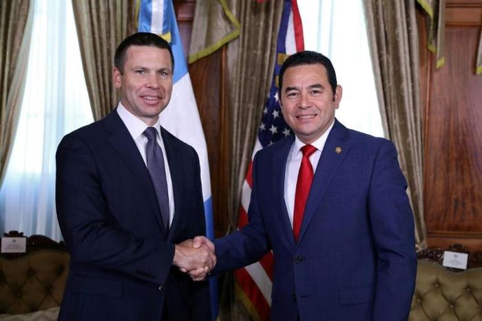 US acting Secretary of Homeland Security Kevin McAleenan (L) shakes hands with Guatemalan President Jimmy Morales at the Culture Palace in Guatemala City on August 1, 2019
